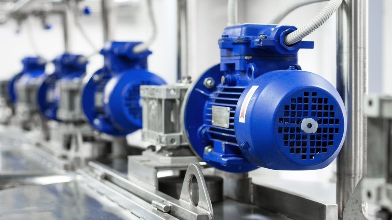 Electric motors on tanks for mixing liquids in beverage production factory.