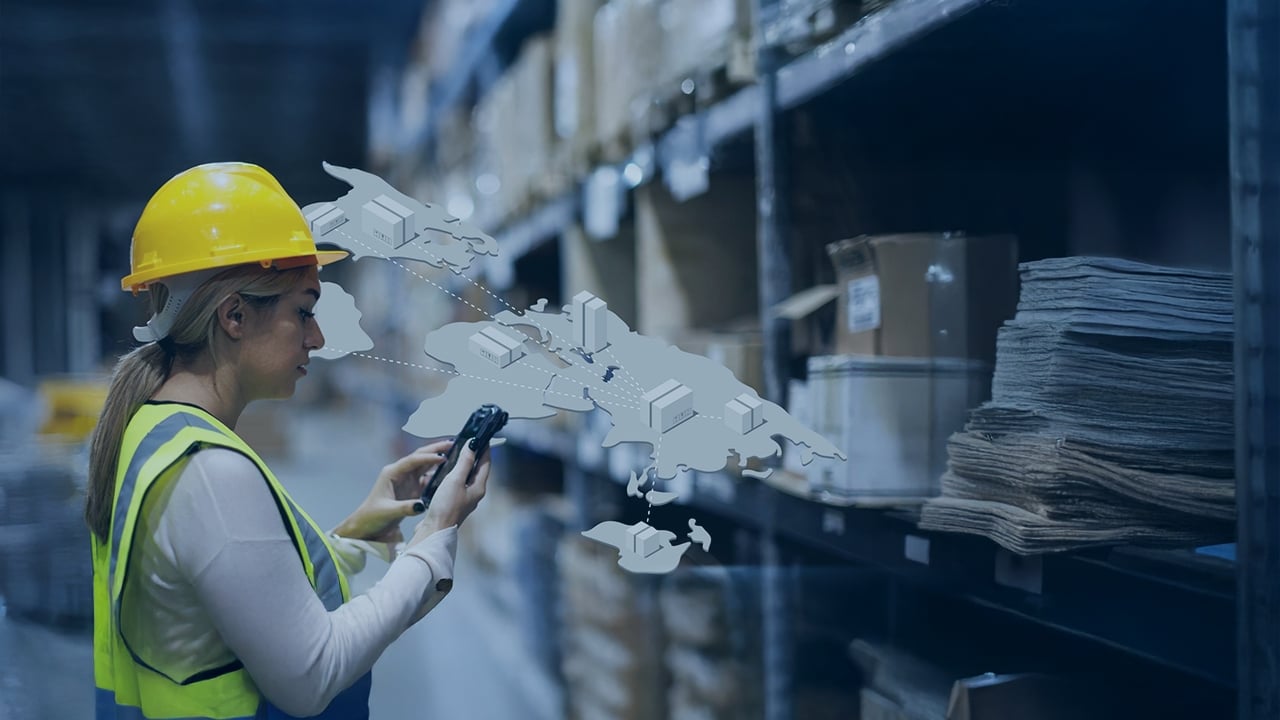 Warehouse worker tracking assets on a smart phone.