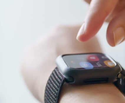 Person interacting with smart watch using finger gestures.